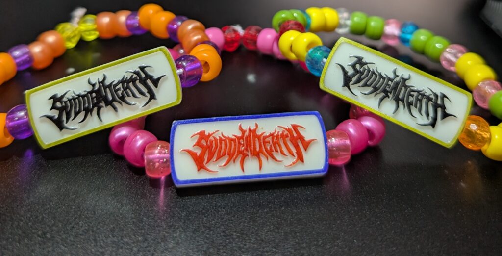 Finished music-inspired charms assembled with colorful kandi beads