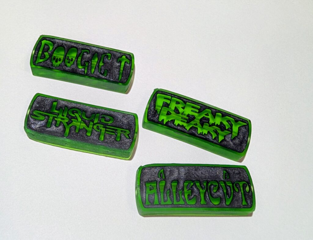 Green music-inspired charms with dark glitter backgrounds
