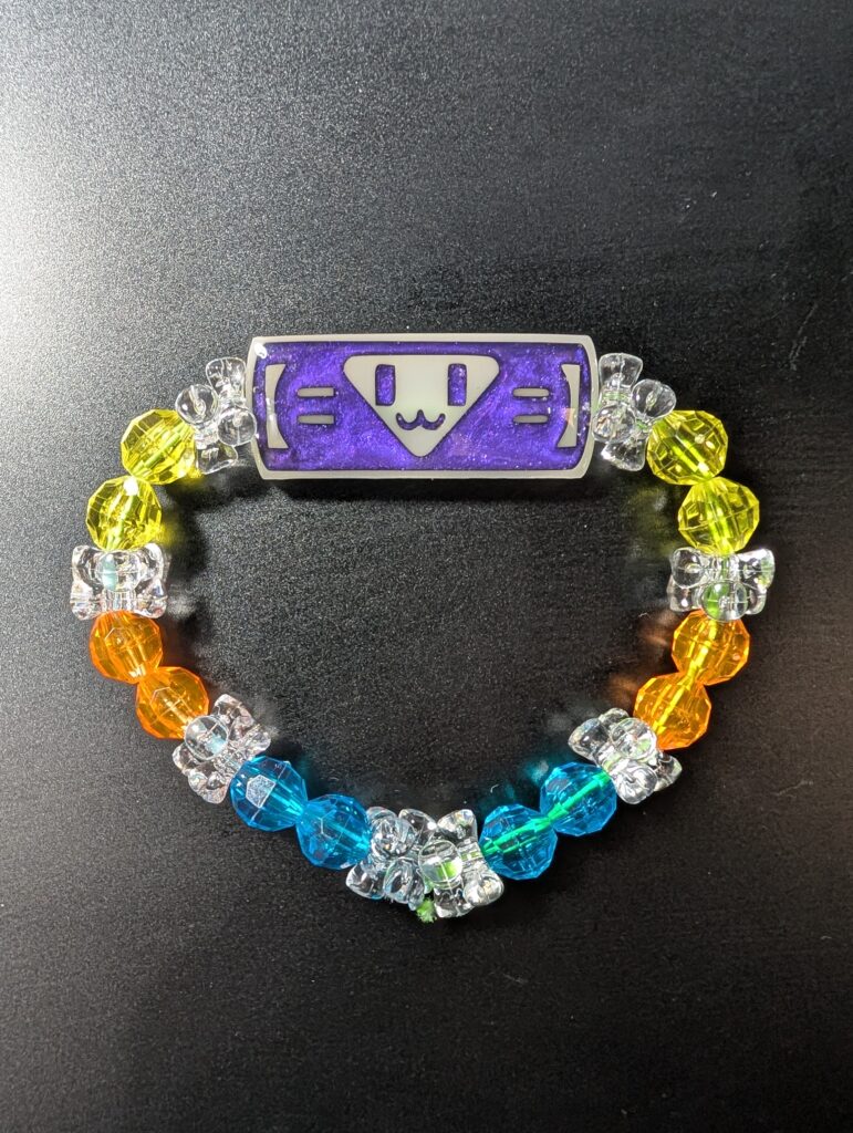 Handmade kandi bracelet with a purple charm and colorful beads