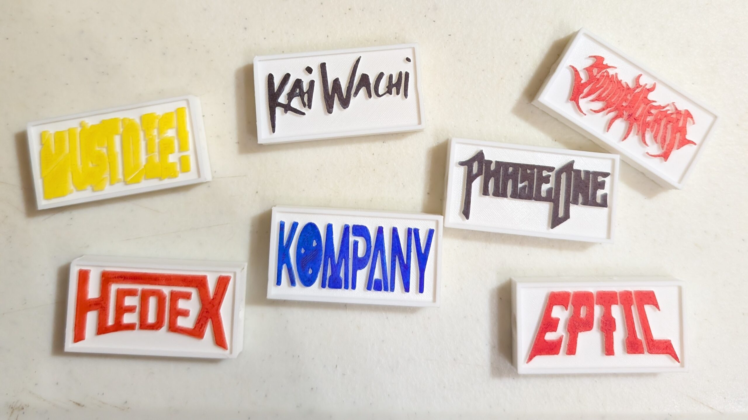 Early white rectangular DJ charms with colorful hand-colored logos