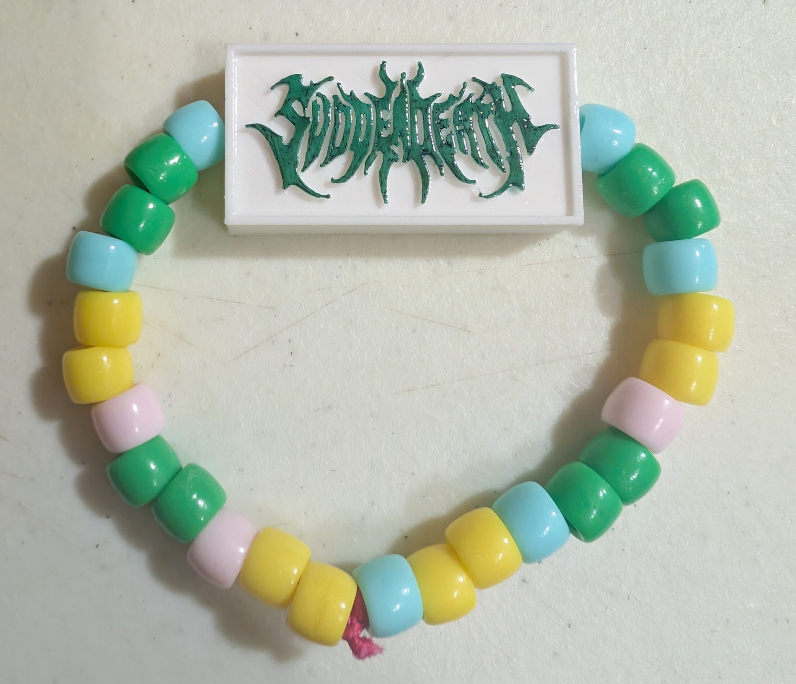 Early Svdden Death charm on a colorful kandi bracelet